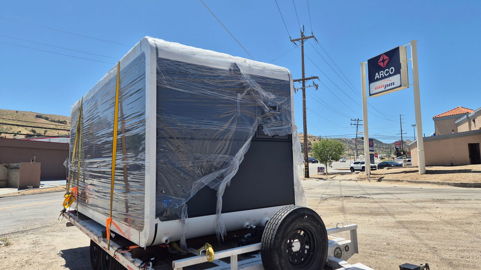Living Pod on flatbed truck - front angle view during transport
