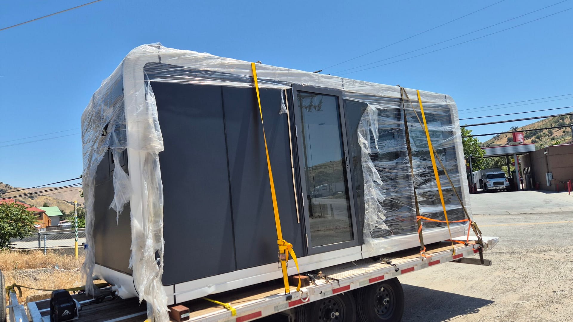 Living Pod on flatbed truck - wide angle during nationwide delivery